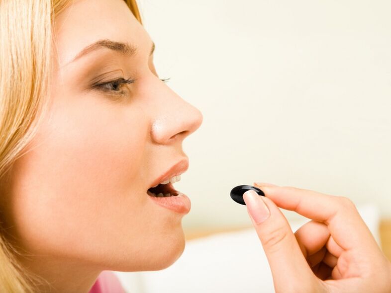 girl takes pills to prevent worms